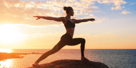 woman doing yoga under the sunset