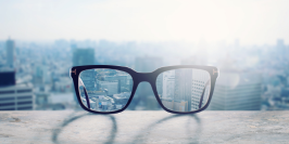 Blurred cityscape through a pair of glasses, creating two distinct areas of clear focus in the foreground.
